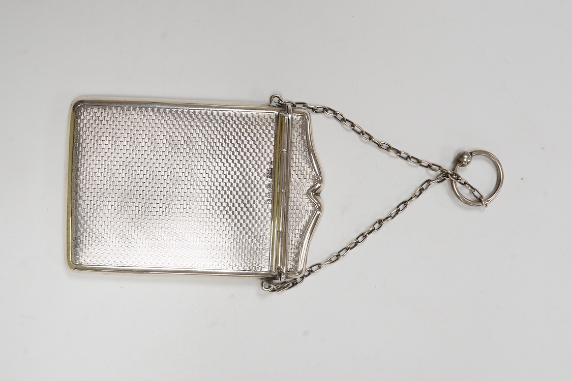 A George V engine turned silver card case, with suspension chain, Synyer & Beddoes, Chester, 1911, 97mm, together with a silver mounted purse, with suspension chain.